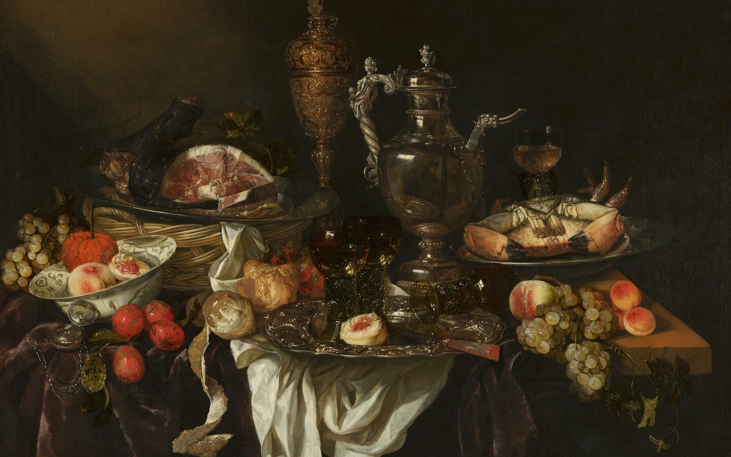 A still life of food and ornate silver objects